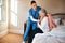 One day well all need a bit of extra help. a young nurse helping a senior woman get dressed in her bedroom at a nursing