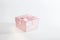 One decorative holiday gift box with ribbon bow for congratulations, surprise, pink present on white background with copy space