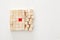 One different red cube block among wooden blocks. Individuality, leadership and uniqueness concept.