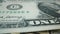 One dollar macro shot. American hundred dollar bills as a rotating background. Extremely US dollars macro view. Details