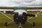 The one engine plane stands on the green grass in a cloudy day. Front view of plain. A small private airfield in Zhytomyr, Ukraine