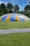 One enormous trampoline in yellow and blue colours. Big trampoline in the summer