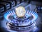 One euro coin on the range burner of a natural gas home stove surrounded by a blue flame. 3D render