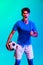 One excited young soccer football player isolated over blue background.