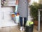 One female people ready to start with the housework. Close to she a plastic bucket with items for cleaning. One alone people with