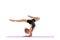 One flexible young girl, rhythmic gymnastics artist practicing isolated on white studio background. Grace in motion
