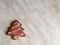 one ginger herringbone-shaped cookies, with pink icing sugar. ginger biscuits in herringbone form with pink icing sugar, grey