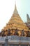 One of the golden chedi with the supporting giants around the base, , Wat Phra Kaew, Bangkok, Thailand