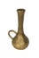 One golden colored long necked vase with handle