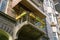 One gray concrete balcony with flower colored vases on metal bars