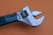 One gray iron adjustable wrench with a handle