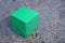 one green dirty square plastic cube toy