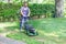 One guy portrait cutting the garden grass