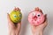 One hand holds apple-smile, other hand holding donut with Googly eyes. Food with Funny faces on white background