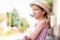 One happy cheerful joyful little girl alone, lone child in a sun hat smiling, portrait, copy space, lifestyle shot. Summer