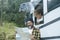 One happy traveler couple looking together a paper guide map to choose plan next travel destination. Living in a van. Nomadic