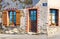 One house with two windows with wooden shutters