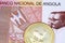 A one hundred Angolan kwanza bank note with a gold South African krugerrand coin