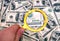 One hundred dollars banknote under magnifier