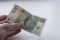 One hundred Polish zloty banknotes in hand. Closeup photo