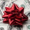 One hundred US dollars bills with holidays bow