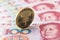 One hundred yuan banknotes, next to an e-RMB gold coin, digital version of the yuan. Concept of new digital currency of the