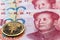 One hundred yuan banknotes, next to an e-RMB gold coin, digital version of the yuan. Concept of new digital currency of the