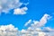 One isolated white cloud in a blue sky. Heaven background. Wallpaper. Beautiful cloudscape. Cumulus clouds. Weather forecast.