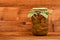 One jar of pear compote at brown vintage wood surface