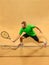 The one jumping player, caucasian fit man, playing tennis on the earthen court