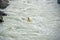 One kayaker on a yellow kayak floats on the mountain river Katun.