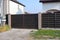 One large closed brown gate made of wooden boards