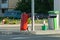 One large metal canister of red fire extinguisher on wheels