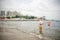 One little boy alone exploring the beach at low tide walking towards the sea coast. happy childhood concept