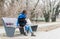 One lonely beautiful girl sitting alone and depressed on the bench in the park feeling abandoned and betrayed from her boyfriend w