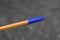 One long plastic orange pen closed with a blue cap