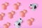 One main cow in front of several small cute pigs and one cow on pastel pink background