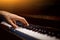 One male hand on the piano. The palm lies on the keys and plays the keyboard instrument in the music school. student learns to