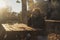 One man alone sitting outdoor on a wooden bench and table in a park having relax and thinking during a golden sunset time. People