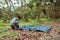 One man setting up pitch a tent on the garden in forest. relax alone