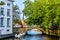 One of the many canals with the stone arch bridges in historic Bruges, Belgium