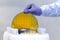One of many gold silicon Wafer with semiconductors in plastic white storage box takes out by hand in gloves inside clean