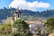 One of the many historic churches in baroque and colonial style amid the hills and vegetation of the city Ou