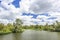 One of the many water courses of the Biesbosch National Park under a beautiful blue sky with white clouds, Netherlands