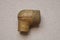 One old brown brass nut plumbing adapter