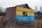 One old colored iron trailer stands in the dry grass