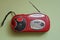 One old red mini mobile tape recorder with radio