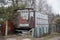 One old rusty metal trailer with a window on the street