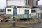 One old rusty metal trailer with a window on the street