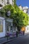 One of the oldest street cafe in Paris Au vieux Paris d`Arcole with violet chairs and glycine after the first lockdown